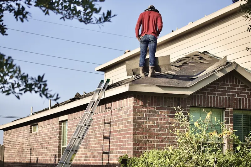Professional roofer working on a residential roof in Pacoima